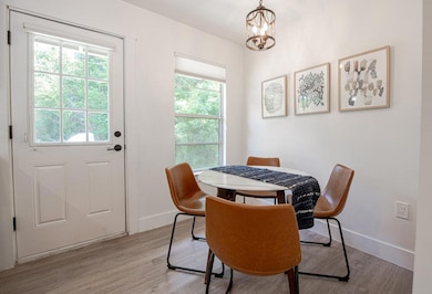 Dining space with baseboards, a chandelier, plent