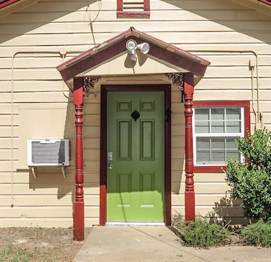 Doorway to property featuring a wall mounted air 