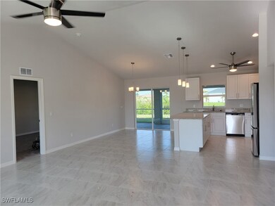 Kitchen with white cabinets, a kitchen island, sta