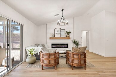 Living area with vaulted ceiling, light wood-style