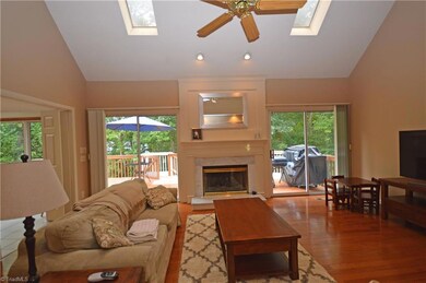Fireplace w/new gas logs, ceiling fan and hardwood floors.  Door leading to deck.