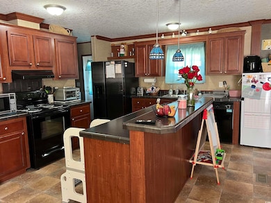 Kitchen featuring ventilation hood, backsplash, a 