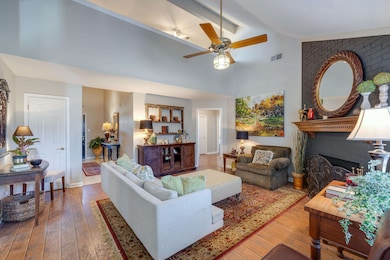Living area with hardwood / wood-style floors, a b