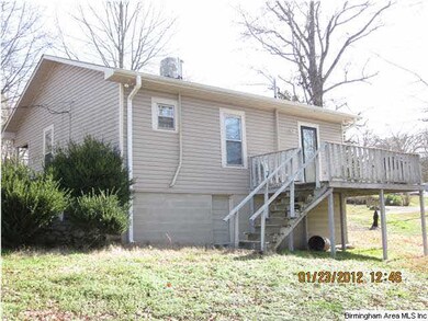 Back of home. Door by deck steps goes to workshop/