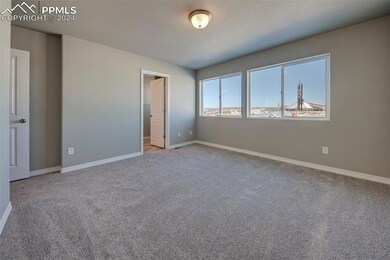 Unfurnished bedroom with a textured ceiling and li