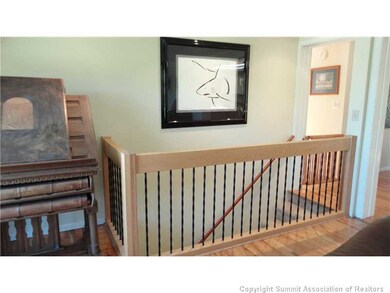 Living Room. Remodeled rod iron stairway gives the