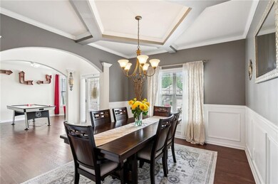 Dining space with a chandelier, arched walkways, a