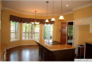 Kitchen has new hardwood floor, pendant lights, ba