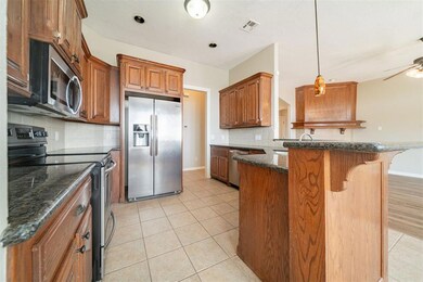 Kitchen featuring visible vents, baseboards, appli