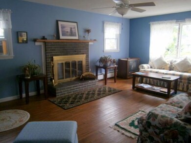 Living room with wood burning fireplace