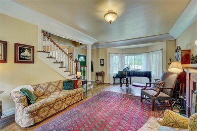 Bay window, stairway and front living area.