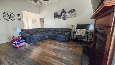 Living room featuring baseboards, wood finished fl
