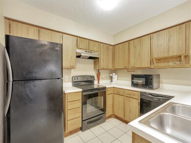 Kitchen has electrical stove, dishwasher, fridge