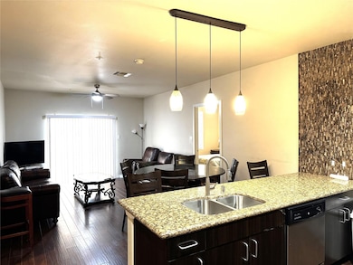 Kitchen featuring dark wood-style flooring, visibl