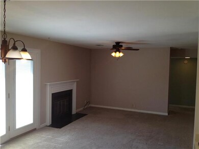 Open floor plan with large living room and fireplace.