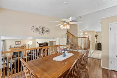 Dining space featuring vaulted ceiling and French doors leading to a large deck