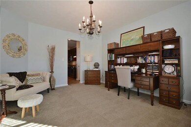 The office has an entry way leading into the kitch