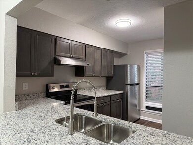 Kitchen with a textured ceiling, stainless steel a