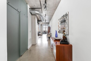 Hallway with concrete flooring and track lighting