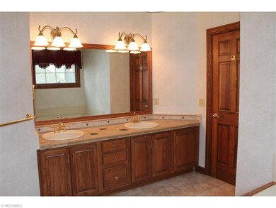 The master bath has tile counters, a jetted tub an