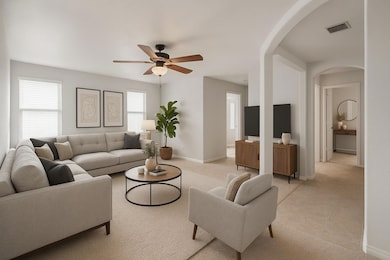 Carpeted living area featuring arched walkways, a