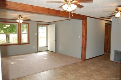 VIEW FROM KITCHEN INTO LIVING ROOM AND ENTRANCE TO