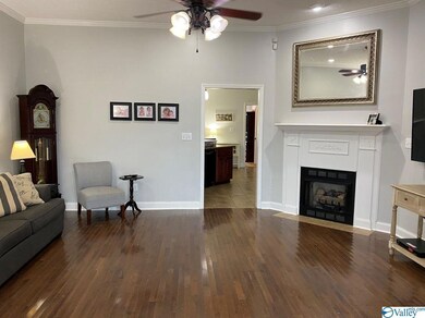 Living room features 10ft ceilings, gas log fireplace, and hardwood flooring.
