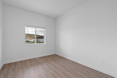 Spare room with baseboards and light wood-style floors