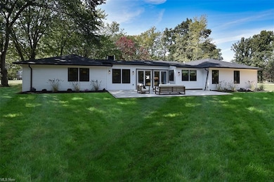 Rear view of property featuring a yard and a patio