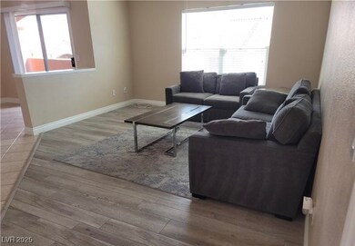 Living area featuring baseboards and wood finished