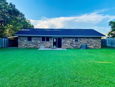 Back of house featuring a lawn, central AC unit, a