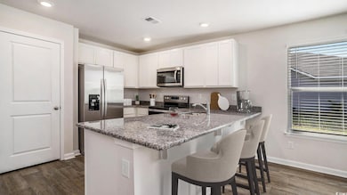 Virtually staged Kitchen with stainless steel appliances, a peninsula, dark wood-style floors, light stone countertops, and recessed lighting