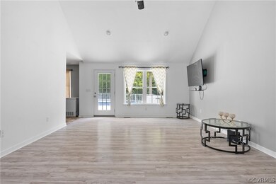 Living room featuring vaulted ceiling and light wo