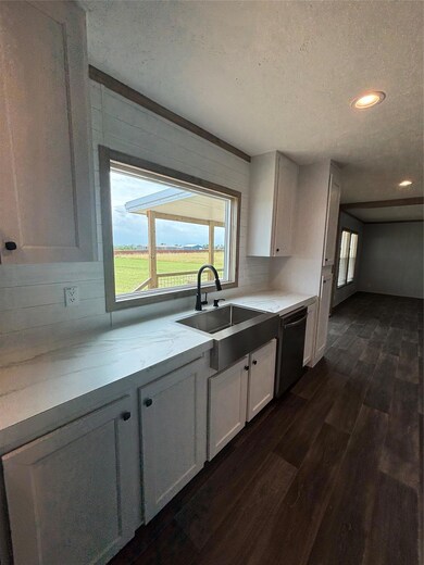 Kitchen featuring dark wood-style floors, white c
