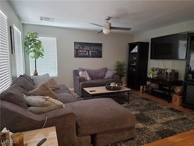Family room featuring ceiling fan, wood blinds and