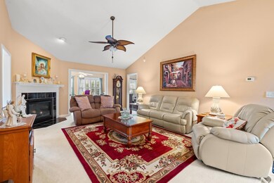 Living room with a tiled fireplace, high vaulted c