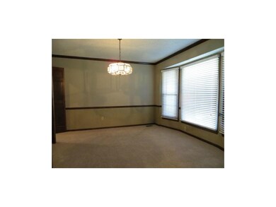 Formal dining room off kitchen with new carpet