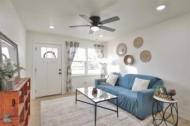 Living room featuring ceiling fan and light hardwo