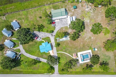 4 cottages on left, main home in middle, apartment in the back and pool to the right. Tons of space for up to 10 RV pads to the right and above pool area