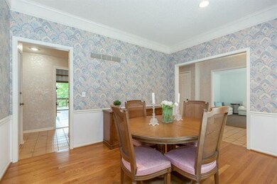 Formal dining room with hardwood floors and planta
