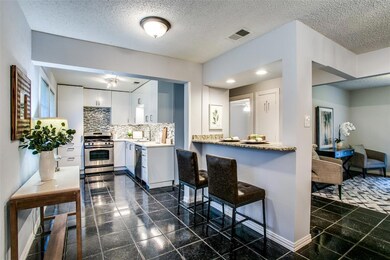 View to the kitchen from entry. Staged photos