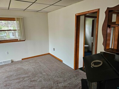 Empty room featuring carpet floors and a paneled c