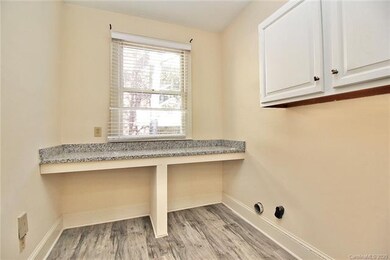 Well Lit Efficient Laundry Room w/ Granite Counter