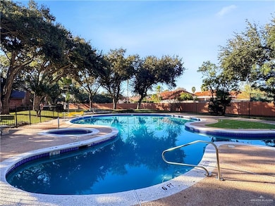 View of swimming pool with an in ground hot tub