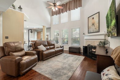 This charming two-story brick home features a well-maintained front yard with mature trees and landscaping. It has a double garage and a welcoming entrance, perfect for families seeking a comfortable and inviting residence.