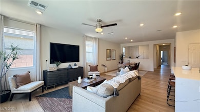 Living room with light wood-style flooring, a ceil