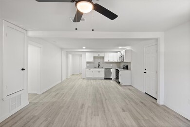 Unfurnished living room with ceiling fan, light wo