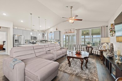 Living room featuring high vaulted ceiling, dark w