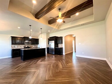 Open concept, beam ceiling, a kitchen island with 