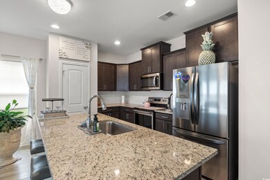Kitchen featuring stainless steel appliances, a si